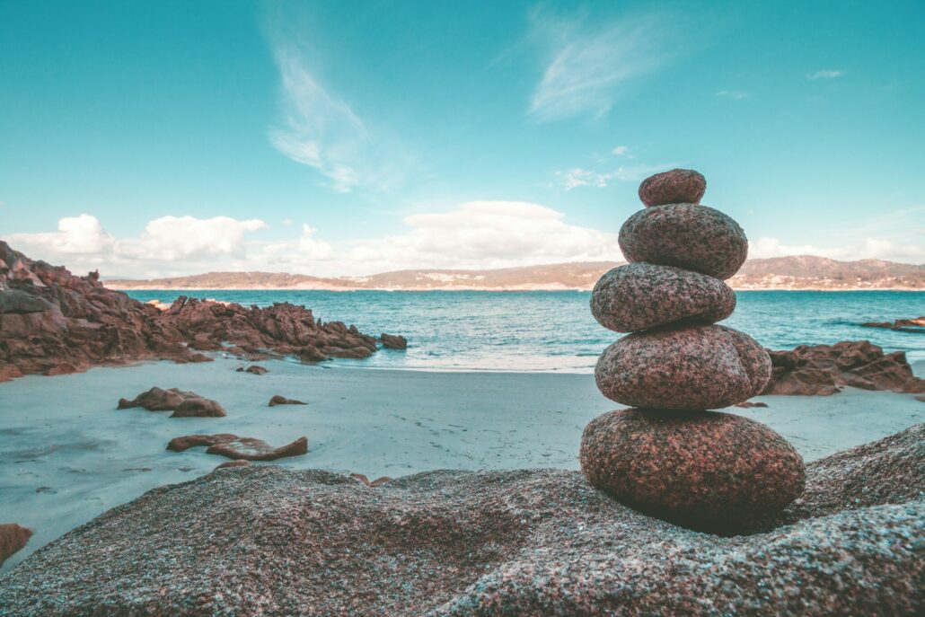 Rocks piled on top of each other with sea in background.
