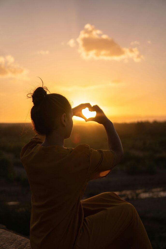 Person standing in front of sunset