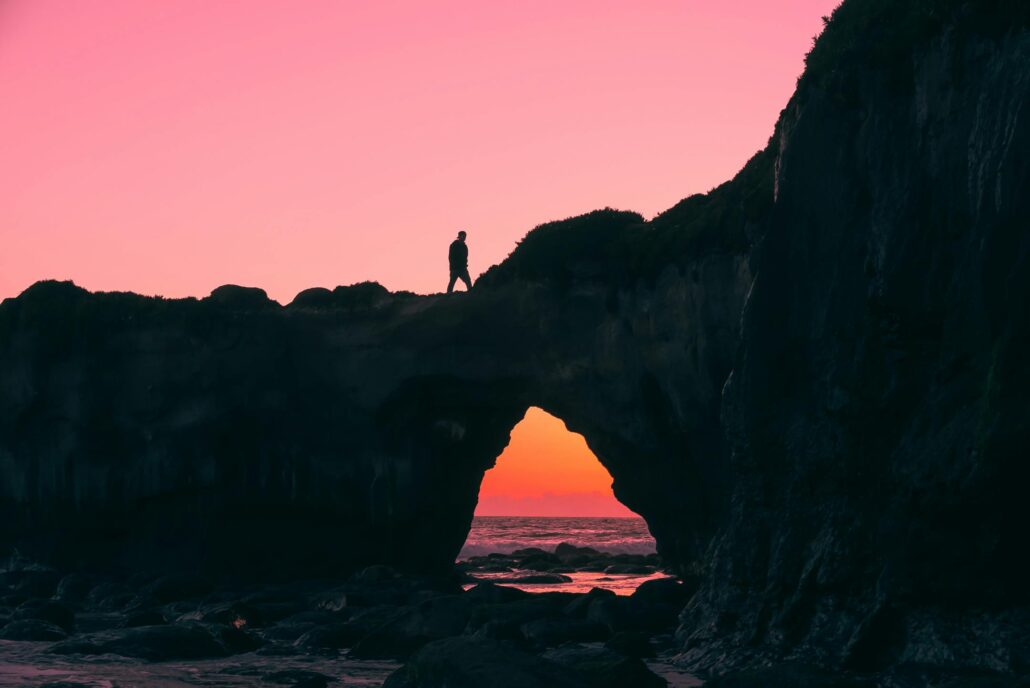 Person walking on a stone arch