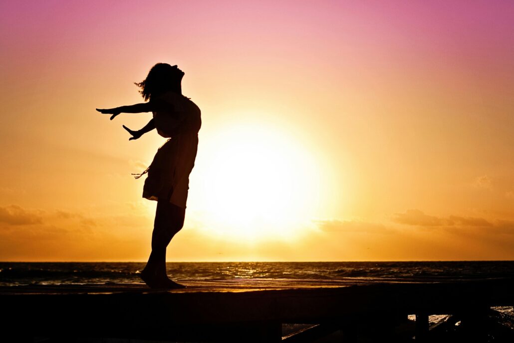 Women standing in front of sunset