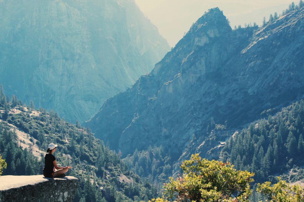 Women sitting on cliff edge.